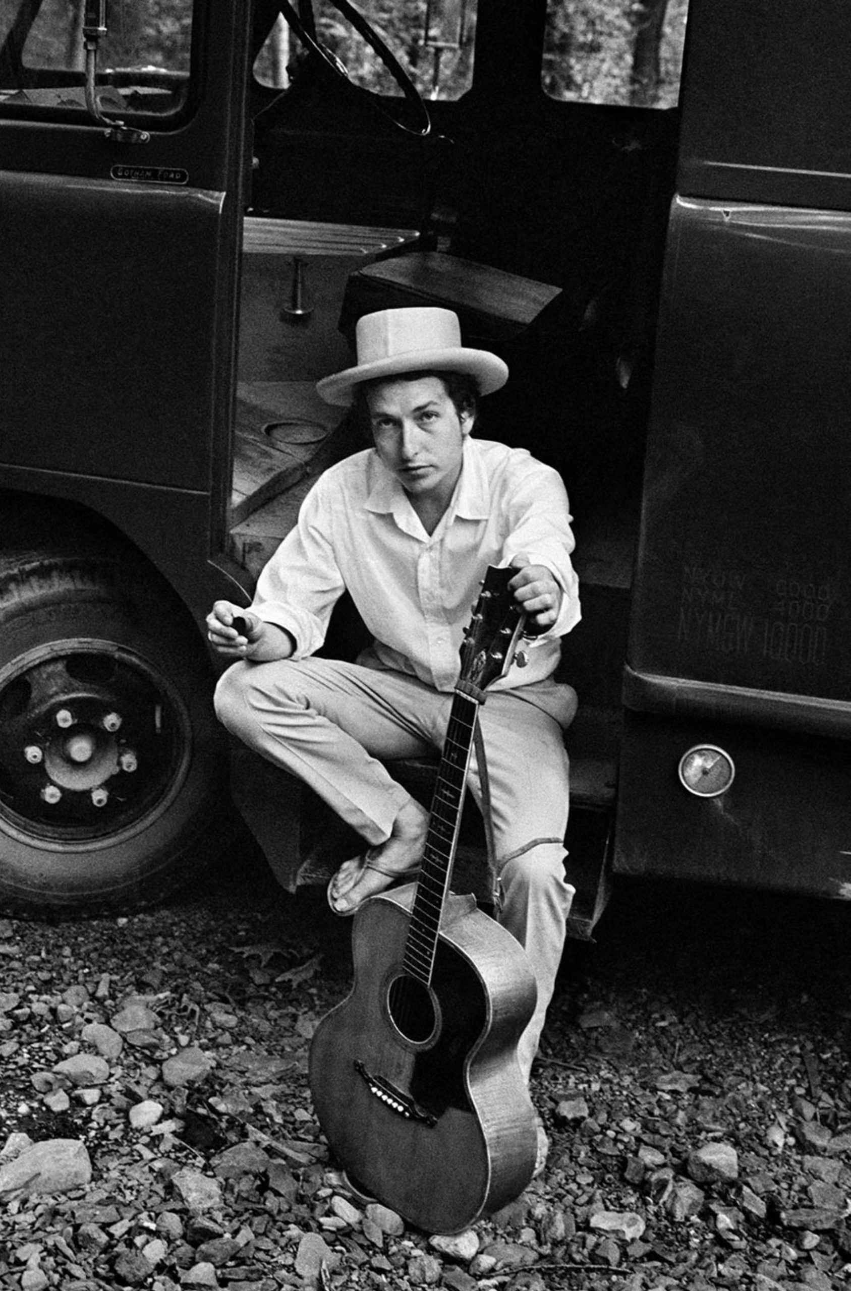 Bob Dylan on his equipment truck outside his Byrdcliffe home. Woodstock, New York. 1968.